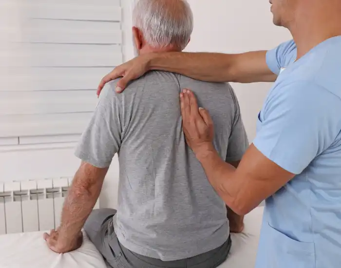 Physical Therapy for Back Pain In-home physical therapy for back pain with therapist assisting patient