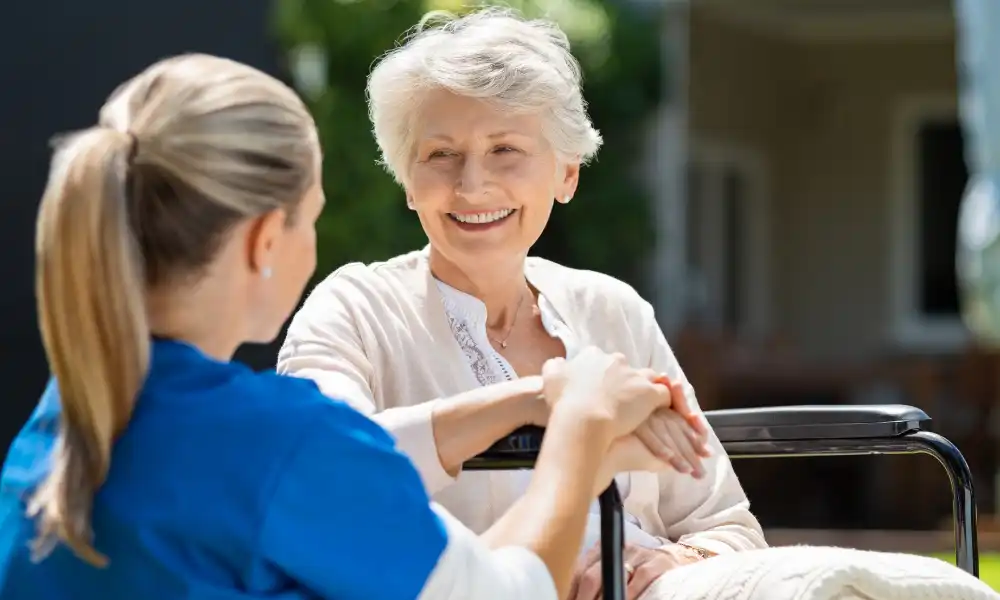 Home health nurse assisting patient after hospital discharge at home