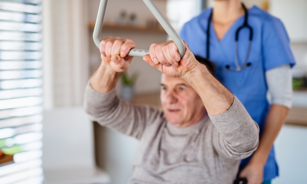 Physical therapist providing rehabilitation exercises during home physical therapy visit